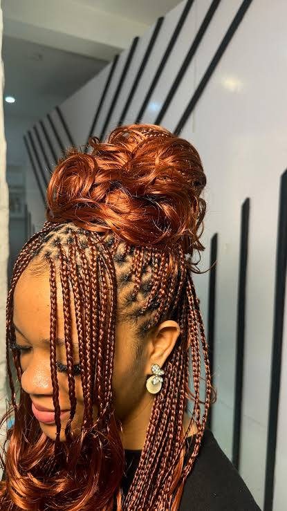 Intricate braids gathered into a warm-toned updo