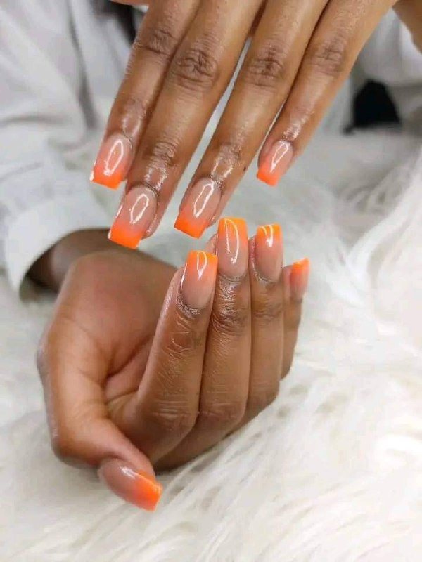 Bright orange nail art with playful details